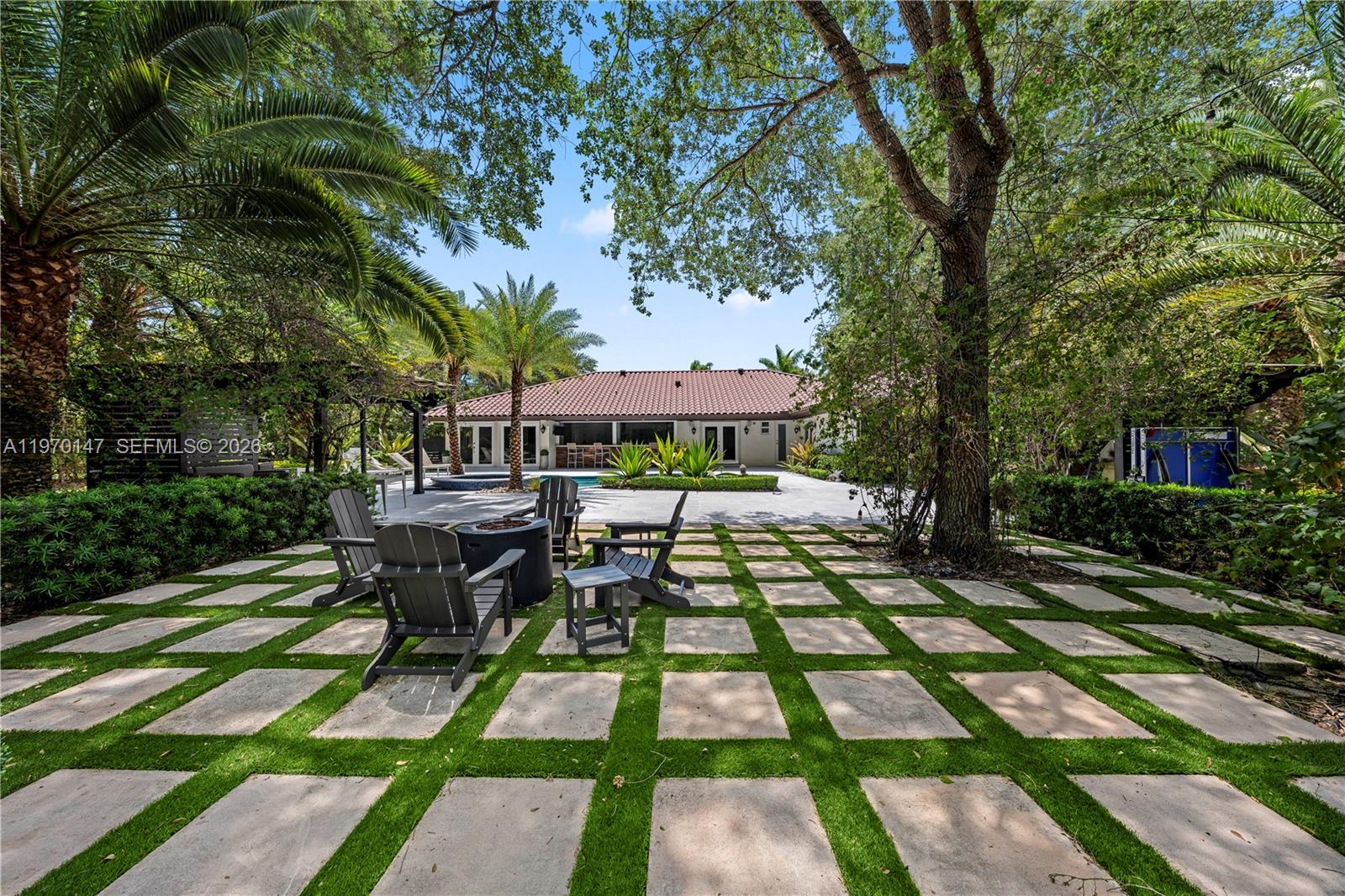 8801 Southwest 124th Street Miami, FL 33176 - Photo 41 of 48 a front view of a house with garden patio and dining space