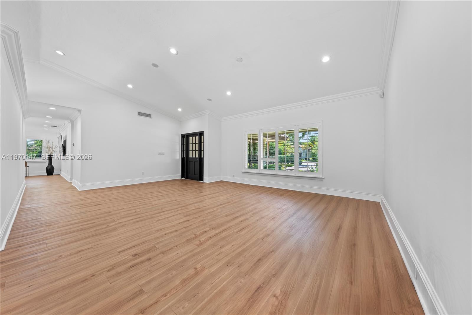 8801 Southwest 124th Street Miami, FL 33176 - Photo 5 of 48 an empty room with wooden floor and windows