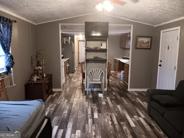 a view of a house with backyard and furniture