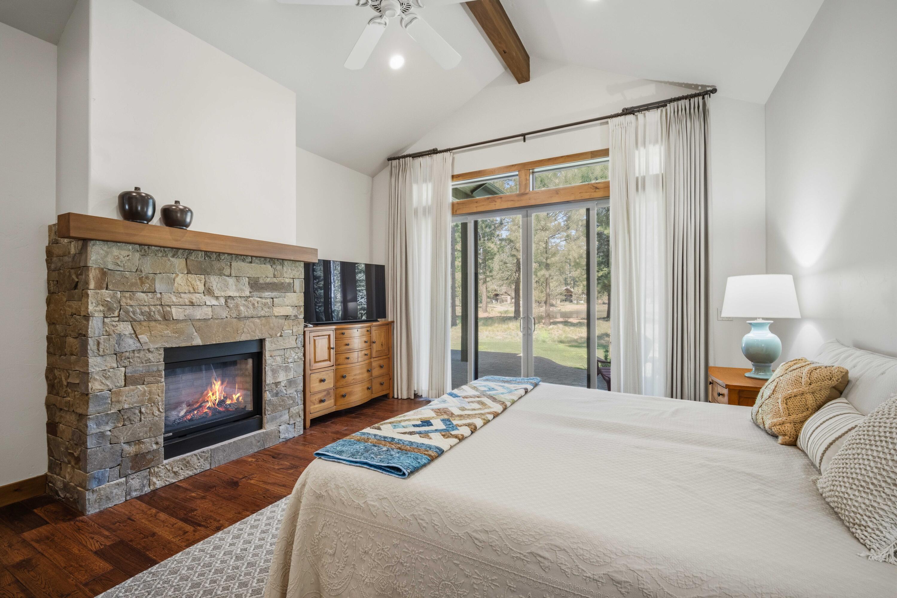 56328 Fireglass Loop Bend, OR 97707 - Photo 24 of 72 Primary bedroom complete with gas fireplace.