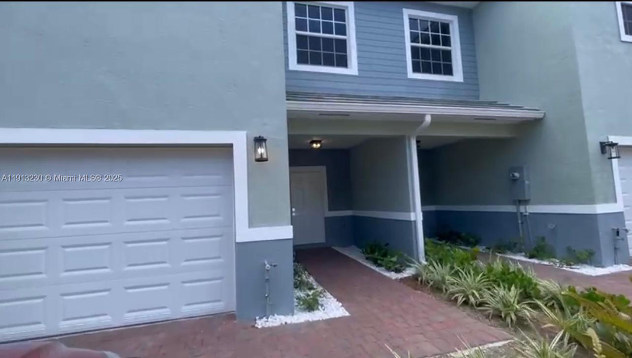 1350 Crystal Way, Unit 101 Delray Beach, FL 33444 - Photo 2 of 13 a front view of a house with a yard