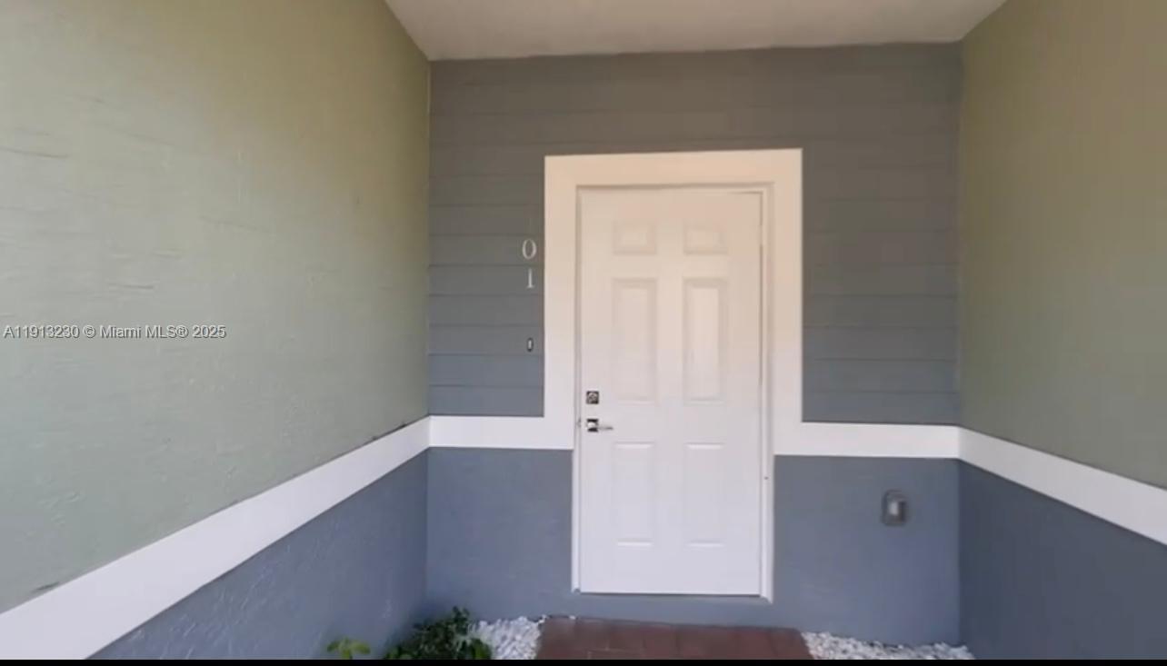 1350 Crystal Way, Unit 101 Delray Beach, FL 33444 - Photo 4 of 13 an empty room with window