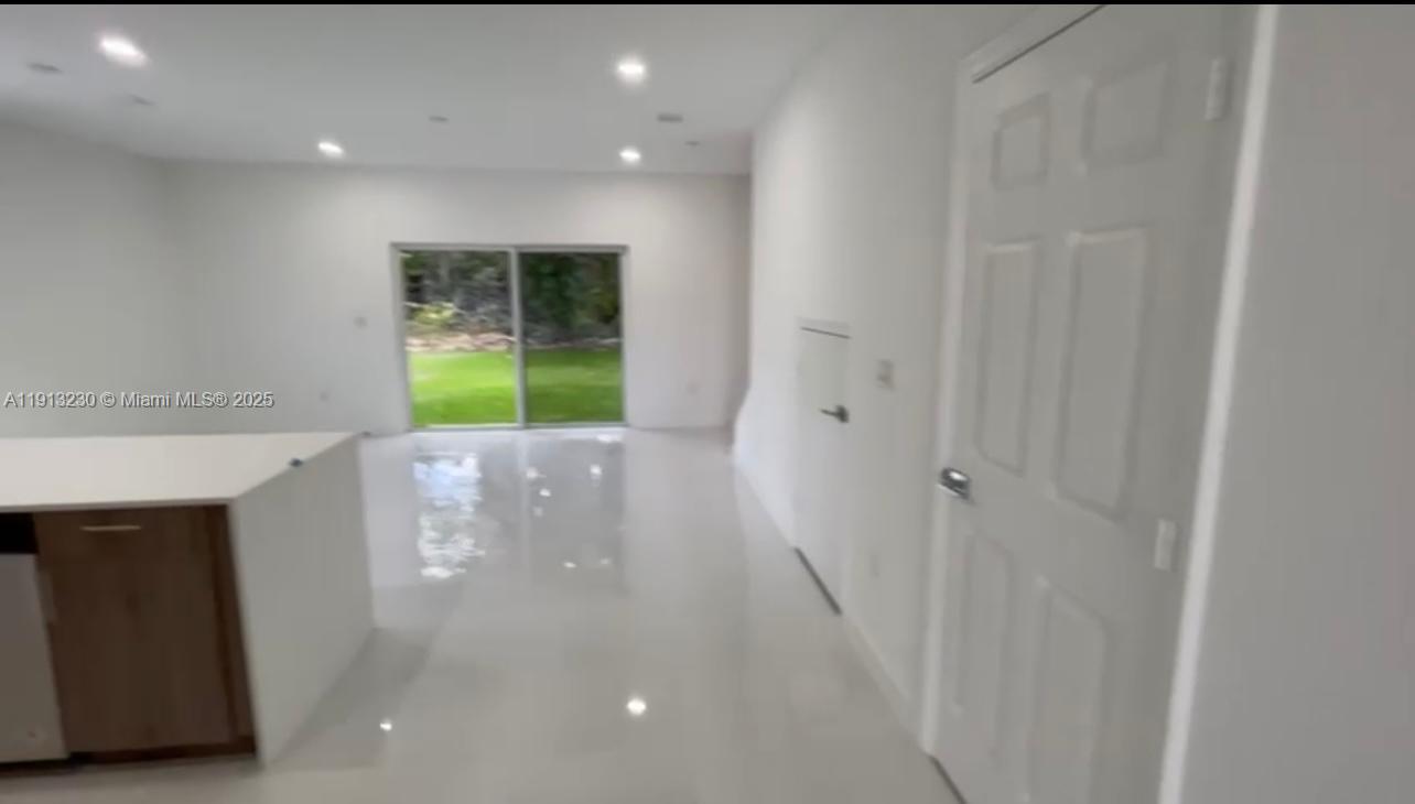 1350 Crystal Way, Unit 101 Delray Beach, FL 33444 - Photo 5 of 13 a view of an empty room with a window