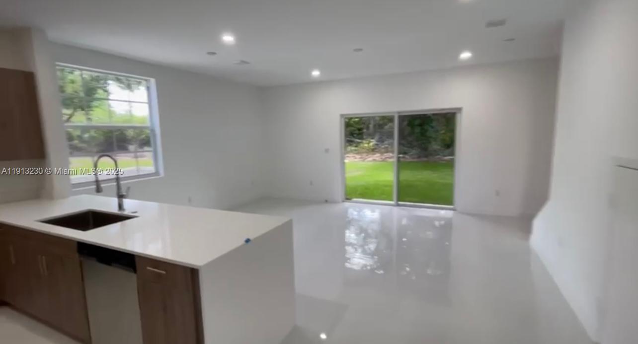 1350 Crystal Way, Unit 101 Delray Beach, FL 33444 - Photo 8 of 13 a kitchen that has a sink and a stove