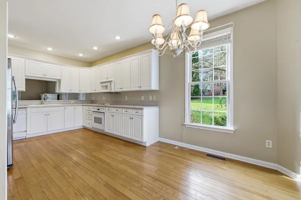 a living room with wooden floor and a fireplace