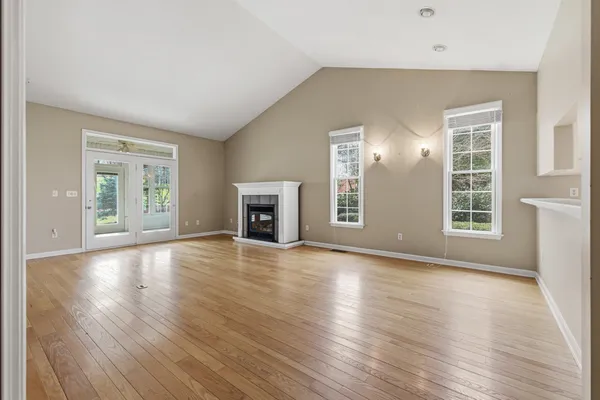 an empty room with a window and a ceiling fan