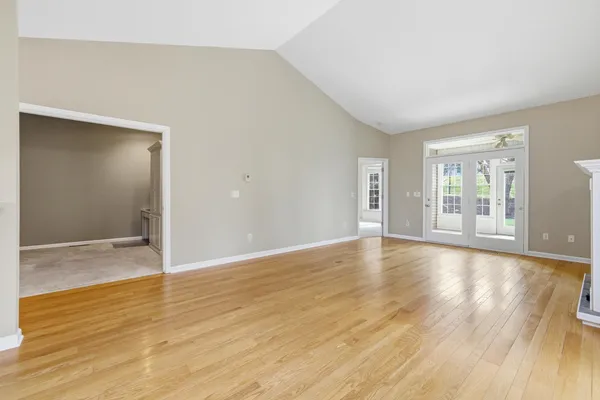 a view of an empty room and a bathroom