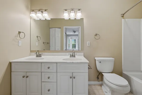 a utility room with cabinets washer and dryer