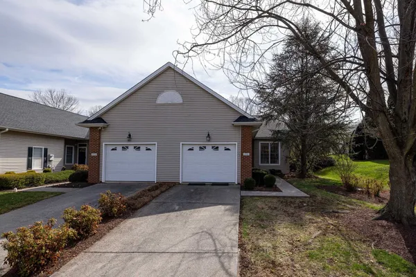 a kitchen with granite countertop white cabinets and stainless steel appliances