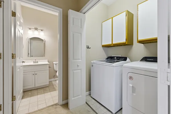 a view of a house with a yard and potted plants