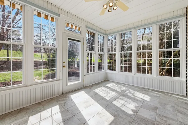 a view of a porch with a door and wooden floor