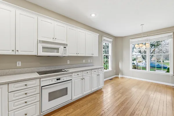 a stove top oven sitting inside of a kitchen
