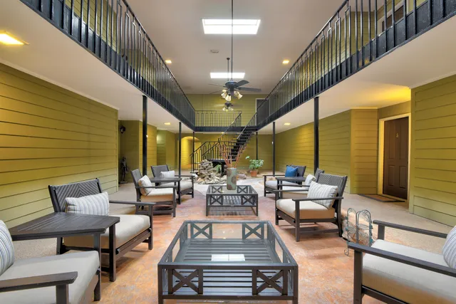 a living room with furniture ceiling fan and a rug