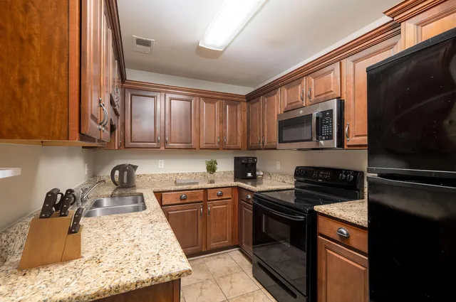 a kitchen with a sink stove and microwave