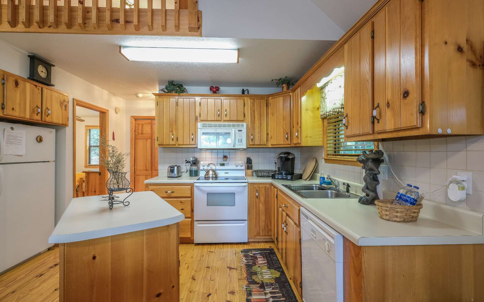 628 Sandy Gap Road Murphy, NC 28906 - Photo 19 of 58 a kitchen with a stove a sink a refrigerator and cabinets