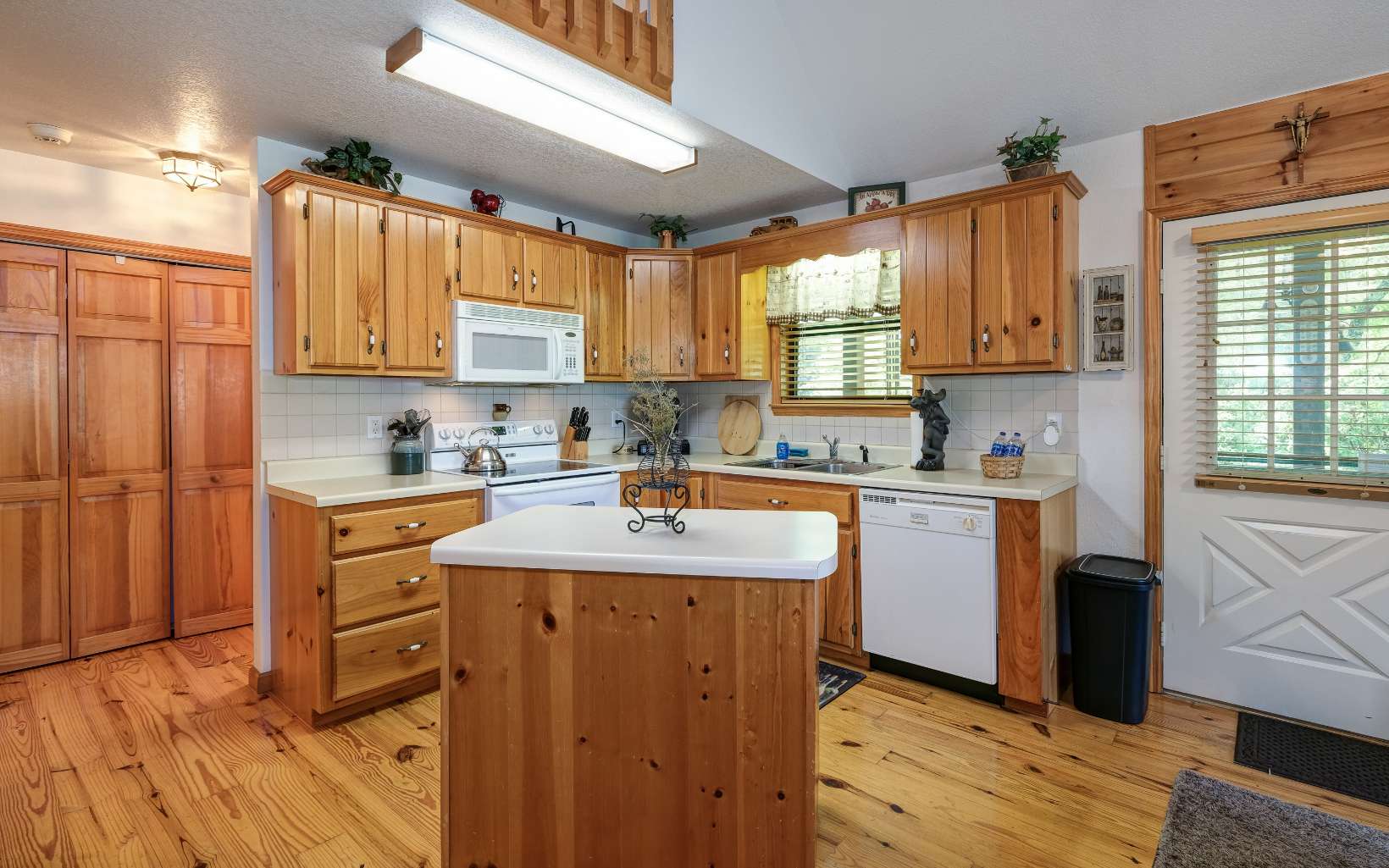 628 Sandy Gap Road Murphy, NC 28906 - Photo 20 of 58 a kitchen with stainless steel appliances granite countertop a sink a stove a refrigerator cabinets and wooden floor