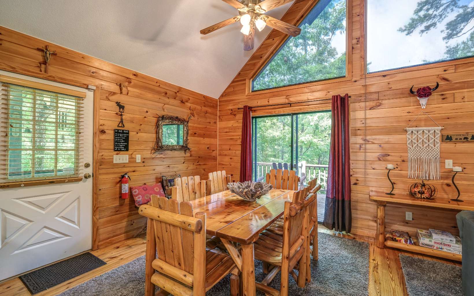 628 Sandy Gap Road Murphy, NC 28906 - Photo 21 of 58 a dining room with furniture a flat screen tv and a floor to ceiling window