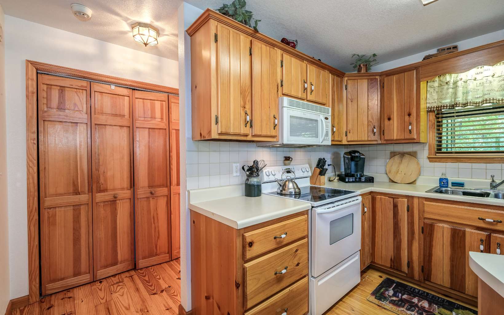 628 Sandy Gap Road Murphy, NC 28906 - Photo 26 of 58 a kitchen with stainless steel appliances granite countertop wooden cabinets a sink and a window