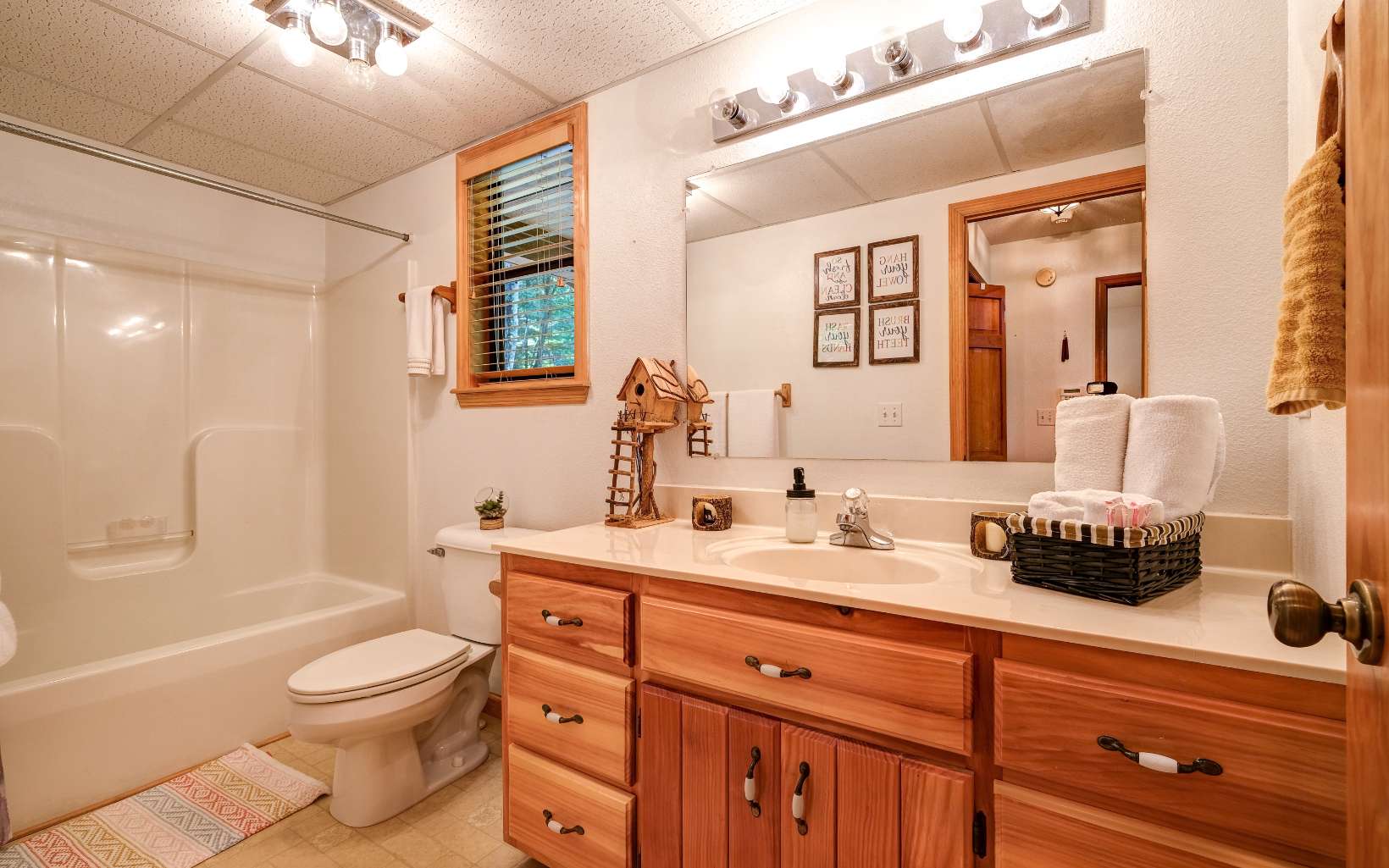 628 Sandy Gap Road Murphy, NC 28906 - Photo 34 of 58 a bathroom with a granite countertop sink toilet a large mirror a bathtub and shower