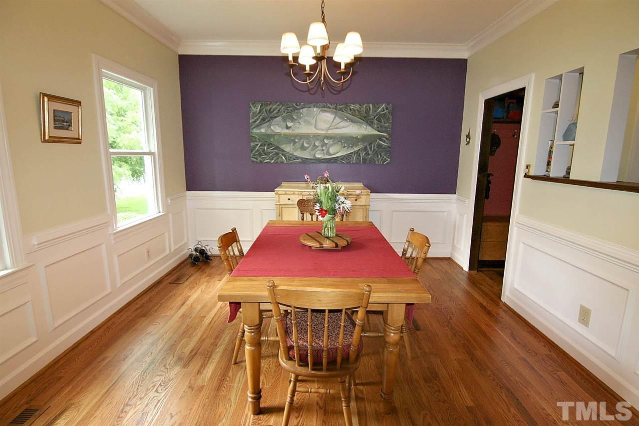 206 Lawrence Road Cary, NC 27511 - Photo 2 of 25 a view of a dining room with furniture a chandelier and wooden floor