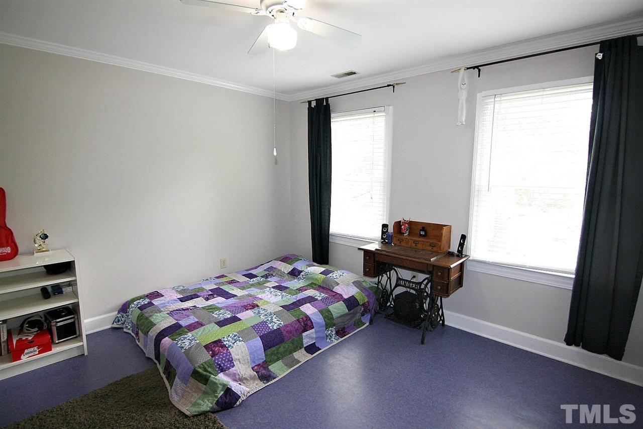 206 Lawrence Road Cary, NC 27511 - Photo 14 of 25 a bedroom with a bed and a window