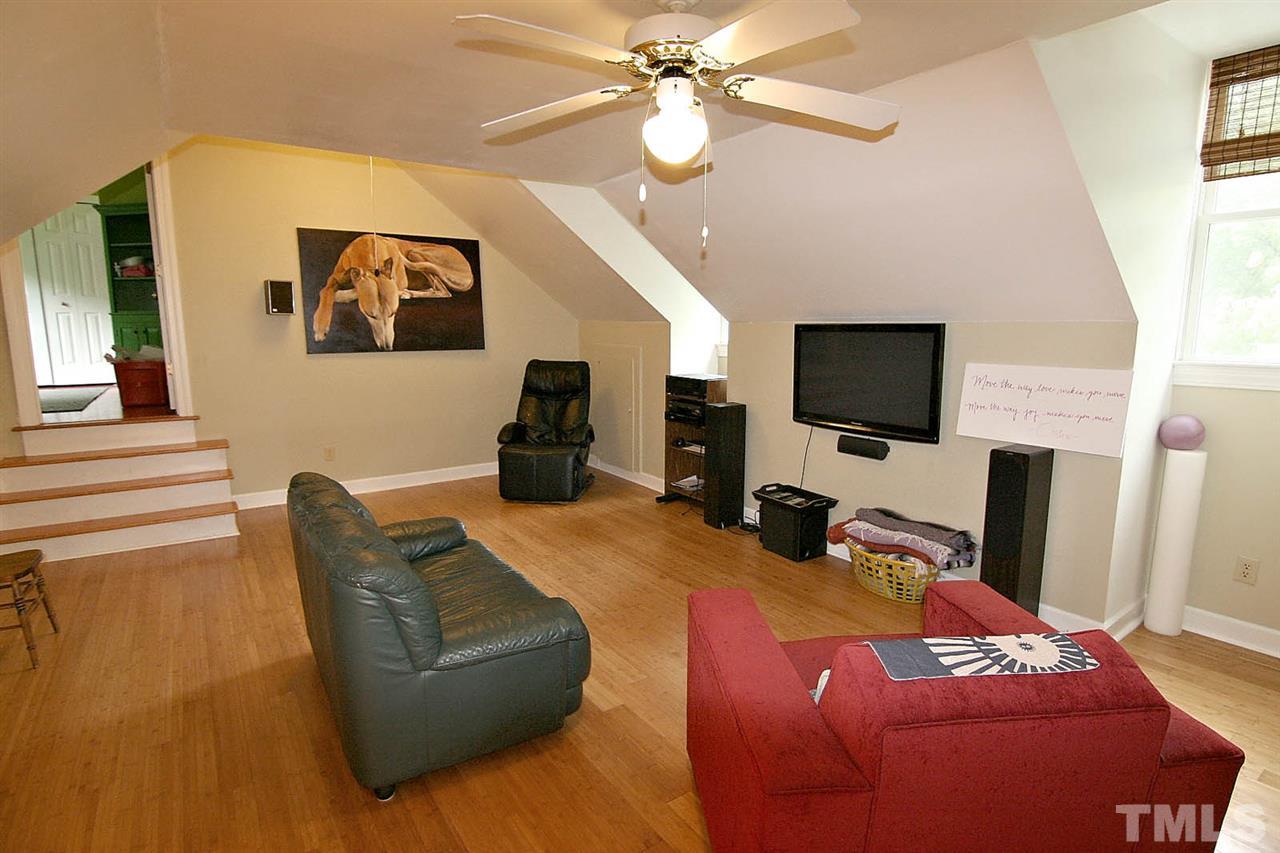 206 Lawrence Road Cary, NC 27511 - Photo 18 of 25 a bedroom with a bed flat screen tv and a couch