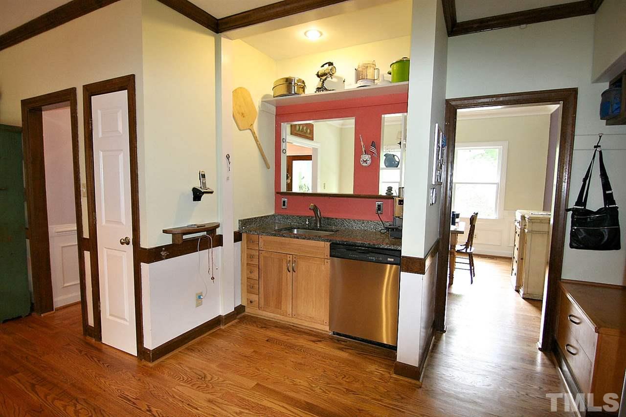 206 Lawrence Road Cary, NC 27511 - Photo 5 of 25 a kitchen with stainless steel appliances granite countertop a stove and a wooden floors