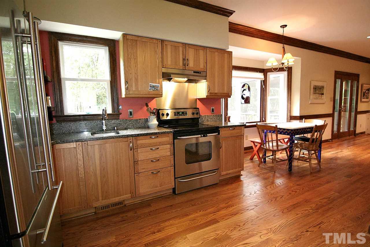 206 Lawrence Road Cary, NC 27511 - Photo 6 of 25 a kitchen with stainless steel appliances granite countertop a stove a sink and a refrigerator