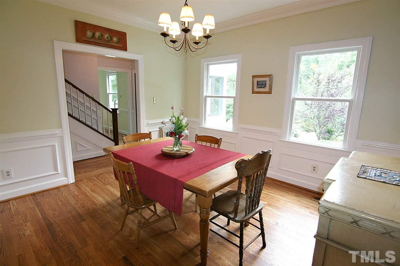 206 Lawrence Road Cary, NC 27511 - Photo 10 of 25 a dining room with furniture a rug and wooden floor