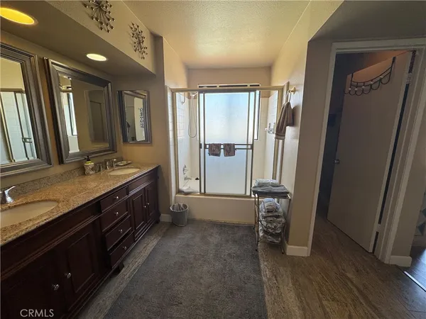 a spacious bathroom with a granite countertop sink and a mirror