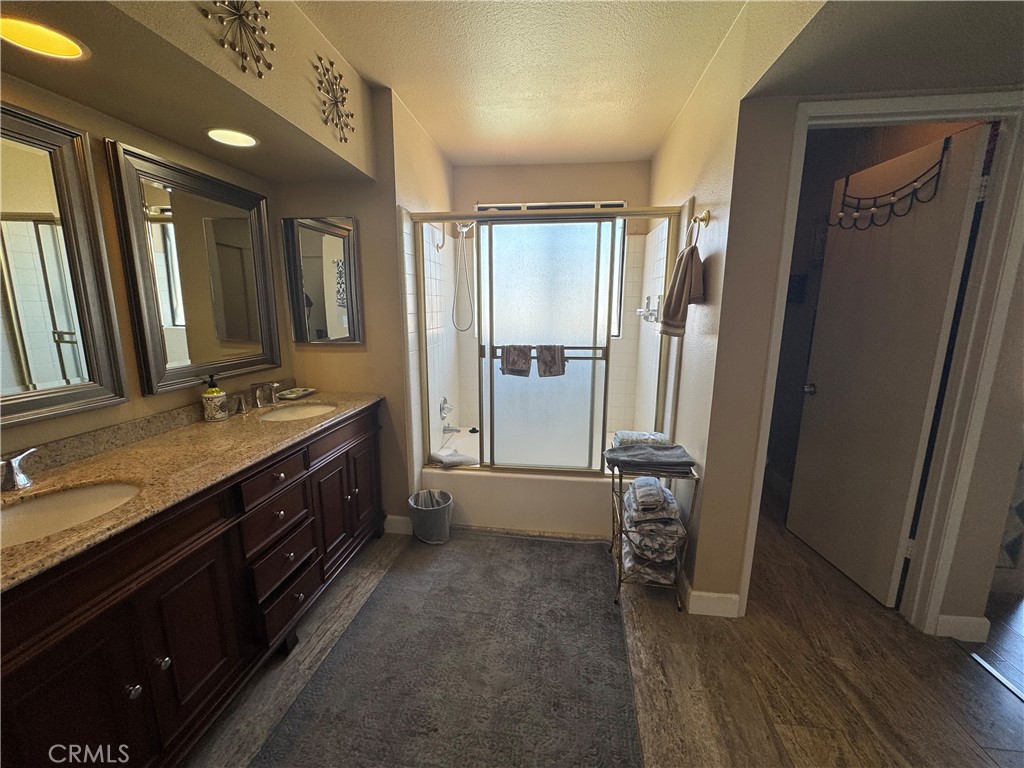 72400 Ridgecrest Lane Palm Desert, CA 92260 - Photo 12 of 13 a spacious bathroom with a granite countertop sink and a mirror