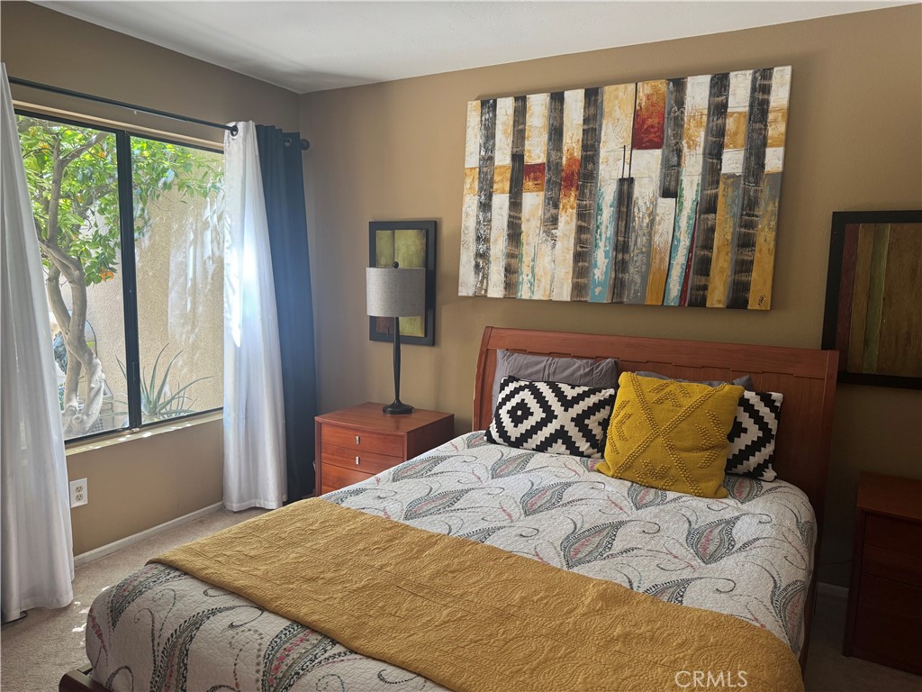 72400 Ridgecrest Lane Palm Desert, CA 92260 - Photo 8 of 13 a bedroom with a bed and a window