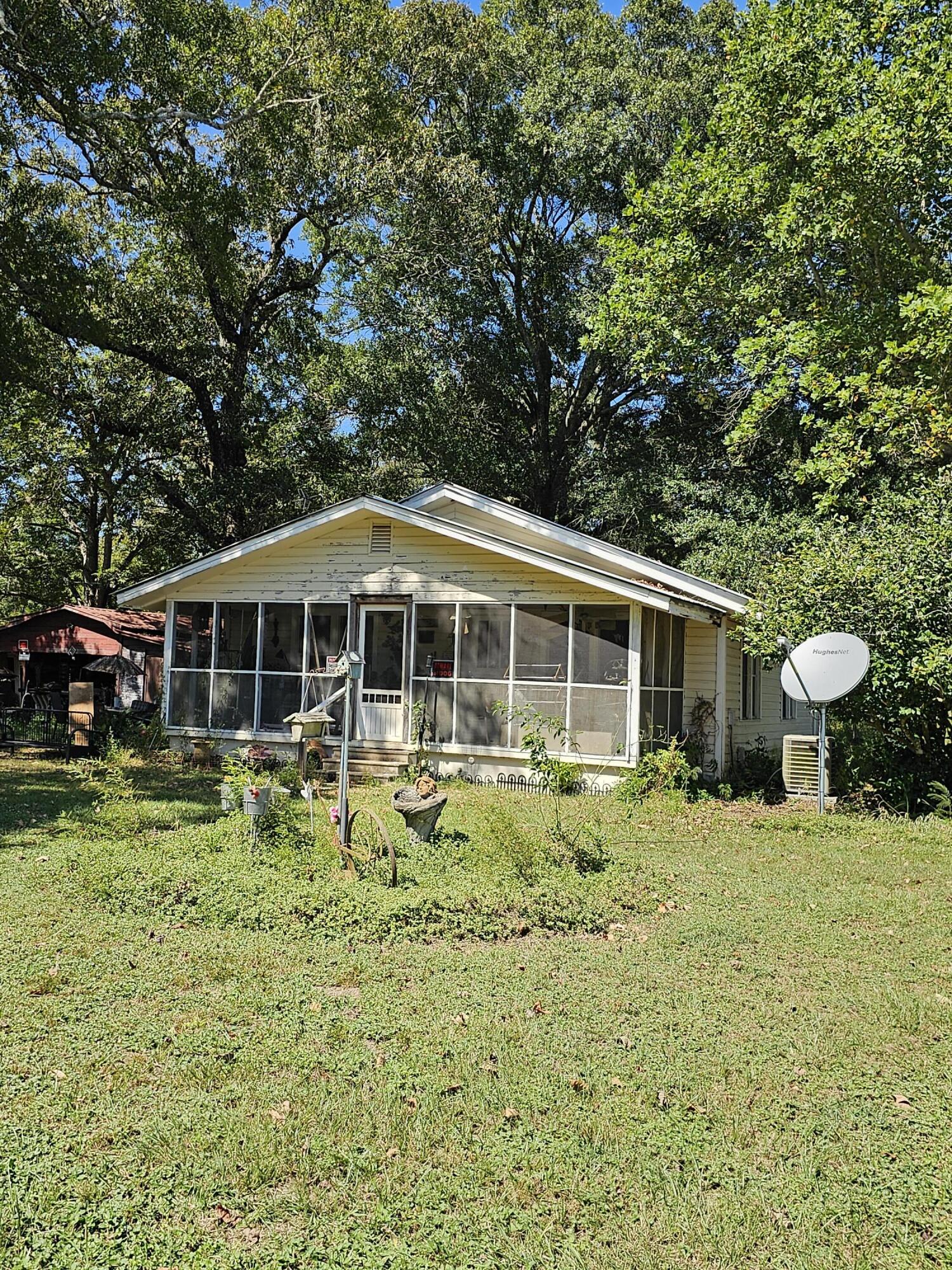 1551 Hester Church Road Baker, FL 32531 - Photo 3 of 5 a backyard of a house with yard table and chairs