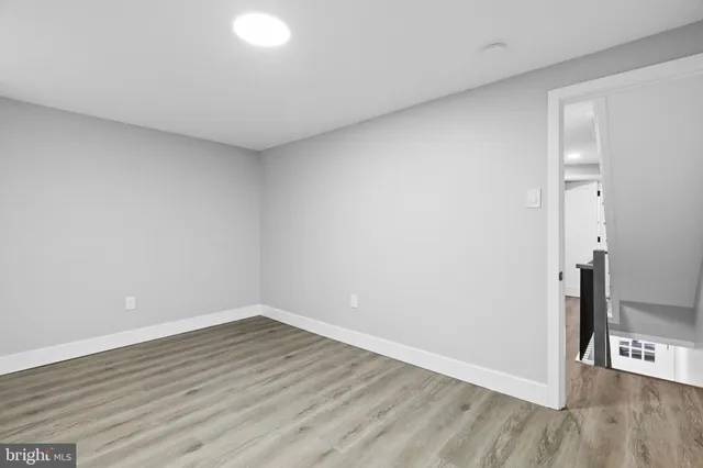 a view of an empty room and wooden floor