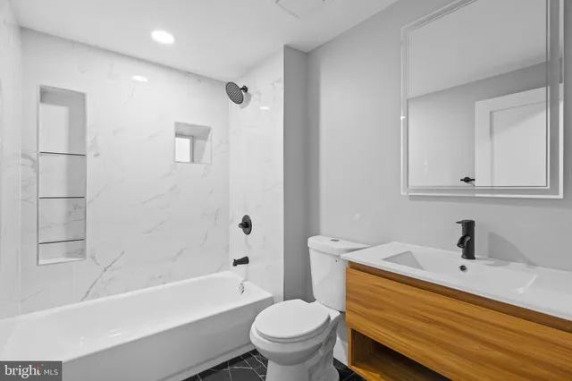 a bathroom with a sink a toilet and a bathtub