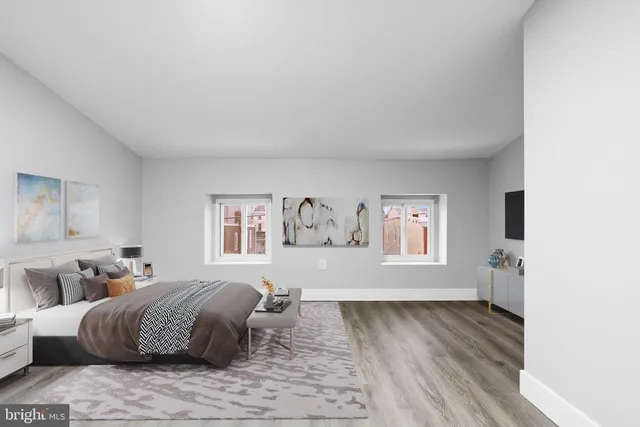 a spacious bedroom with a bed and a couch