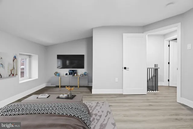 a bedroom with a bed and a flat screen tv