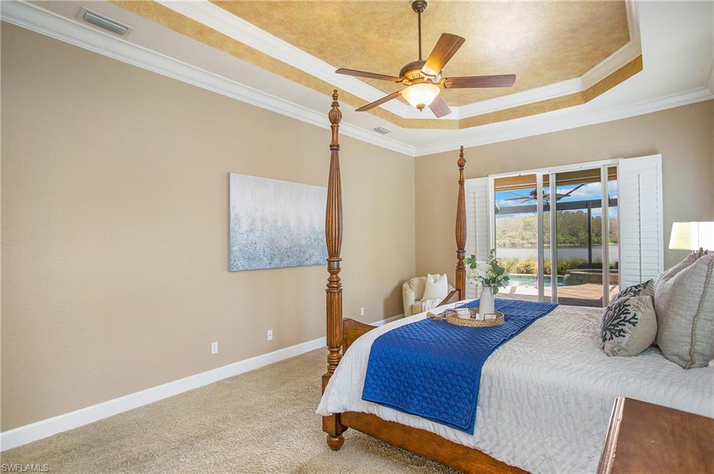 9807 Nickel Ridge Circle Naples, FL 34120 - Photo 12 of 50 a bedroom with a bed and ceiling fan