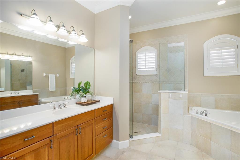 9807 Nickel Ridge Circle Naples, FL 34120 - Photo 14 of 50 a spacious bathroom with a double vanity sink mirror and bathtub