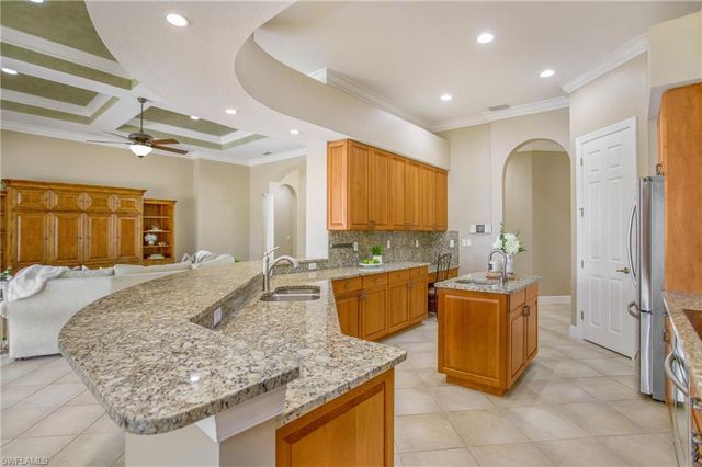 a kitchen with granite countertop a sink stainless steel appliances a counter space and cabinets