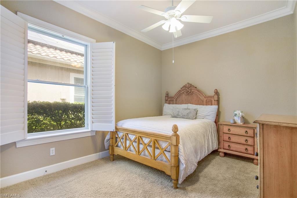9807 Nickel Ridge Circle Naples, FL 34120 - Photo 32 of 50 a bedroom with a bed and window