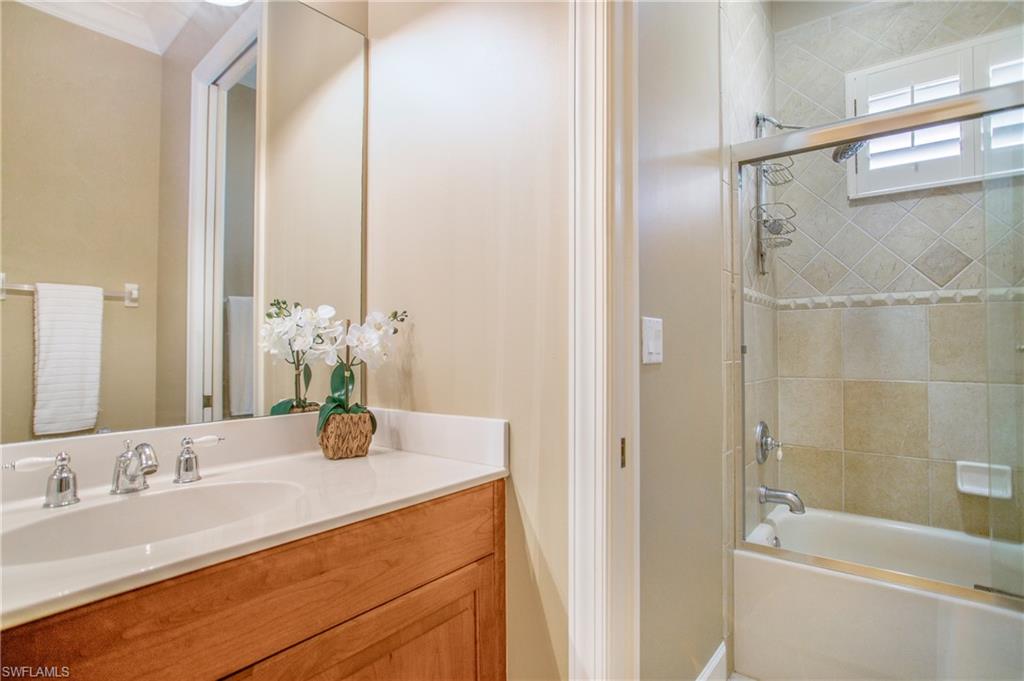9807 Nickel Ridge Circle Naples, FL 34120 - Photo 33 of 50 a bathroom with a granite countertop sink and a mirror