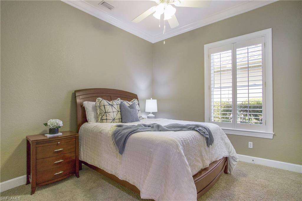 9807 Nickel Ridge Circle Naples, FL 34120 - Photo 34 of 50 a bedroom with a bed and window