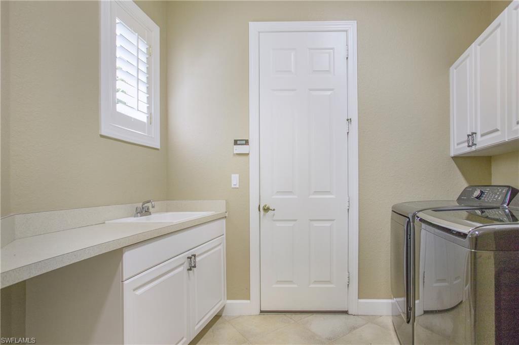 9807 Nickel Ridge Circle Naples, FL 34120 - Photo 35 of 50 a bathroom with a sink toilet and vanity