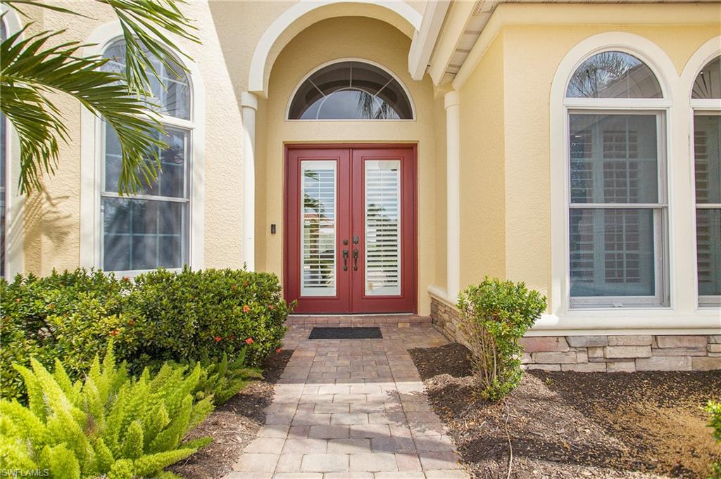 9807 Nickel Ridge Circle Naples, FL 34120 - Photo 36 of 50 a front view of a house with garden