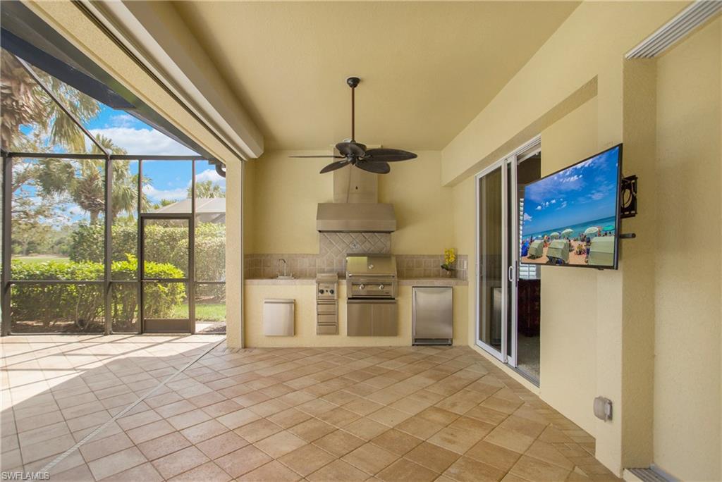 9807 Nickel Ridge Circle Naples, FL 34120 - Photo 37 of 50 a kitchen with stainless steel appliances granite countertop a stove and a refrigerator