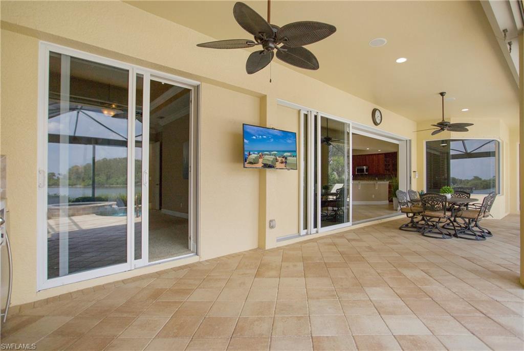 9807 Nickel Ridge Circle Naples, FL 34120 - Photo 39 of 50 a view of a livingroom with furniture and a ceiling fan