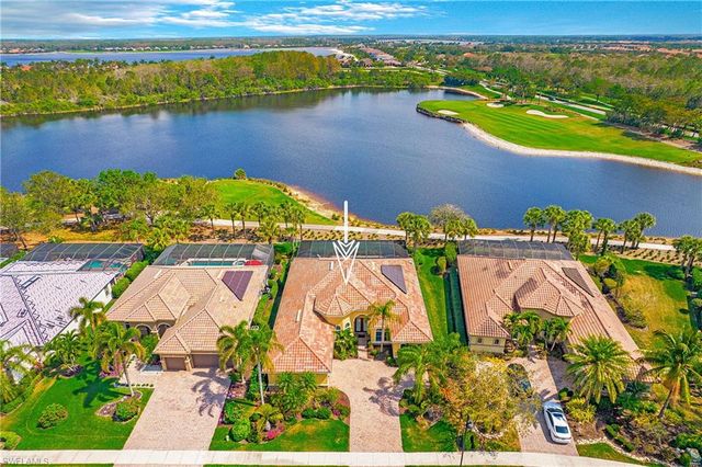 an aerial view of a house with a garden and lake view