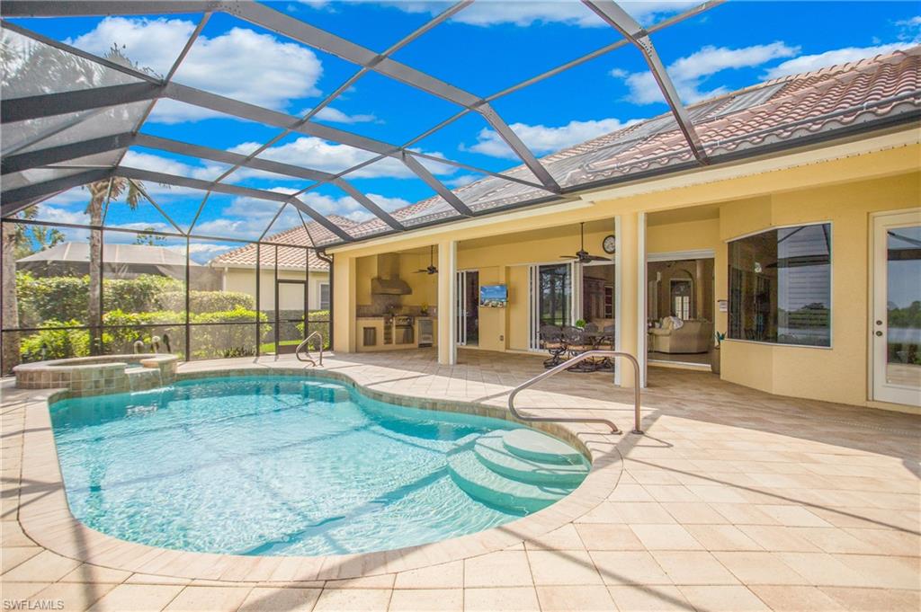 9807 Nickel Ridge Circle Naples, FL 34120 - Photo 41 of 50 a swimming pool with yard in front of it