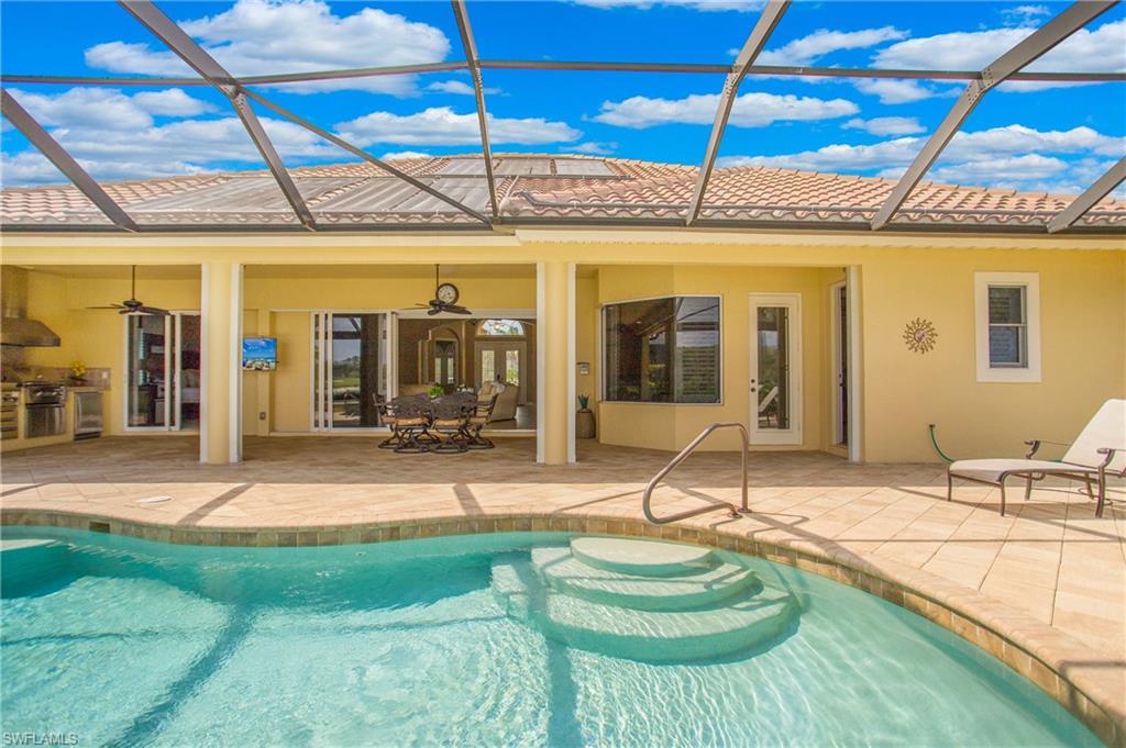 9807 Nickel Ridge Circle Naples, FL 34120 - Photo 42 of 50 a swimming pool with patio outdoor seating and yard